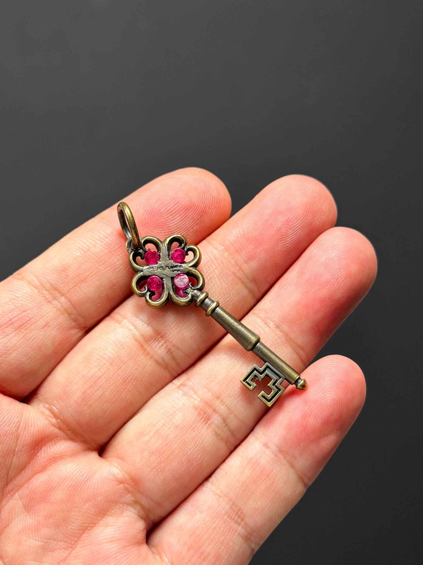 Rare Vintage Steel Flame Bronze Key Pendant with Ruby Inlay
