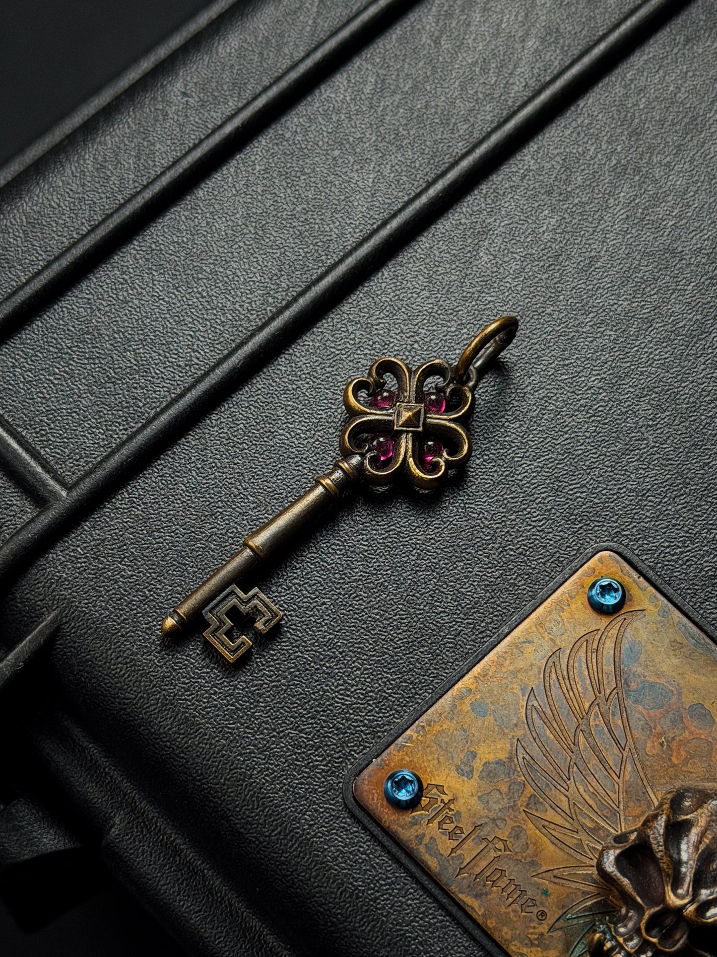 Rare Vintage Steel Flame Bronze Key Pendant with Ruby Inlay