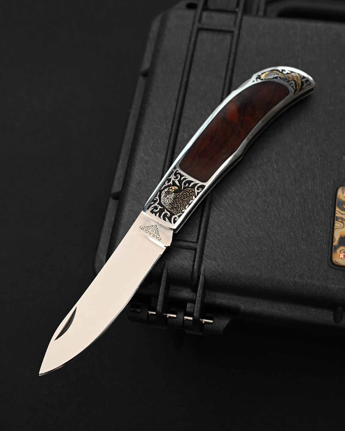 Rare Katsuhiko Miura Japanese custom folding knife featuring double-sided eagle engravings on a stainless steel handle with natural wood inlay, mirror-polished stainless steel blade, and back-lock mechanism