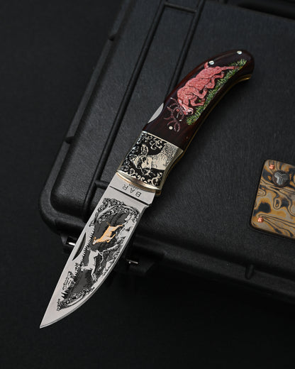 Rare Katsuhiko Miura Japanese custom folding knife featuring double-sided deer and scrollwork engravings on the stainless steel blade and bolsters, carved deer motif on the natural wooden handle, made in Japan