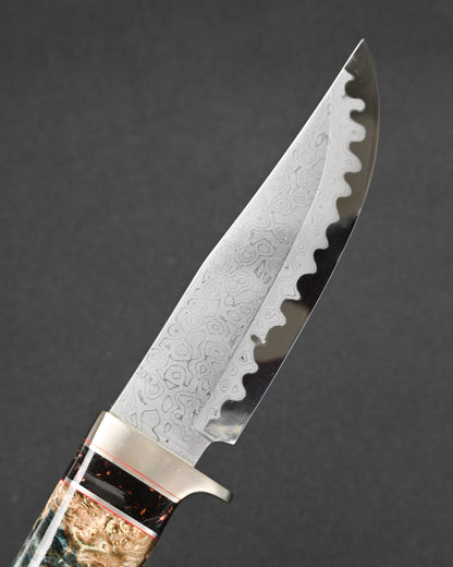 Close-up of the forged layered Damascus steel blade on a Nishida Hamono handmade Japanese custom knife.