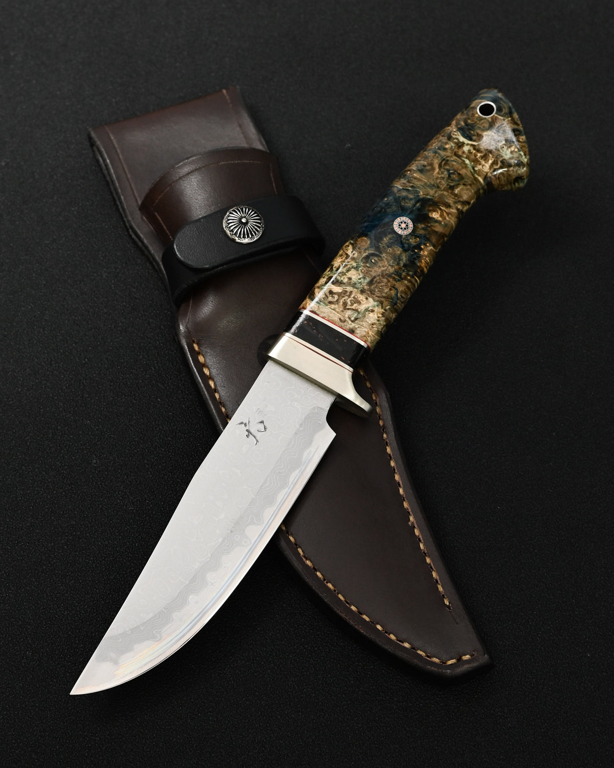 Rare Nishida Hamono handmade Japanese outdoor knife featuring a forged layered Damascus blade and stabilized burl wood handle.