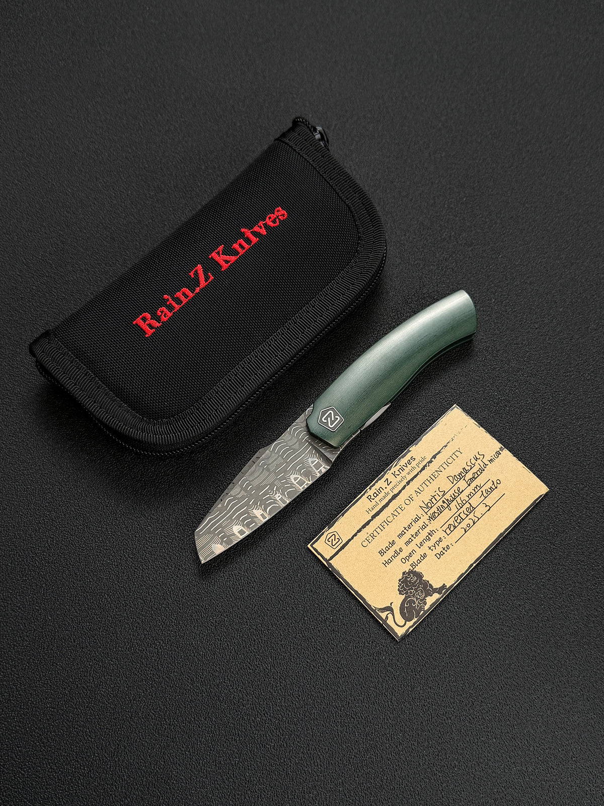 Rare Rain.Z Knives Custom Folding Knife – Norris TanPai Damascus / Westinghouse Emerald Micarta / Zirconium Pivot