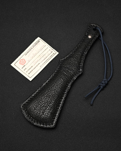 Sunizumi Shoten × Wtopia collaborative bear leather EDC paddle featuring genuine bear leather, an internal steel plate, bronze and silver Sunizumi emblem, and 550 paracord lanyard, made in Japan