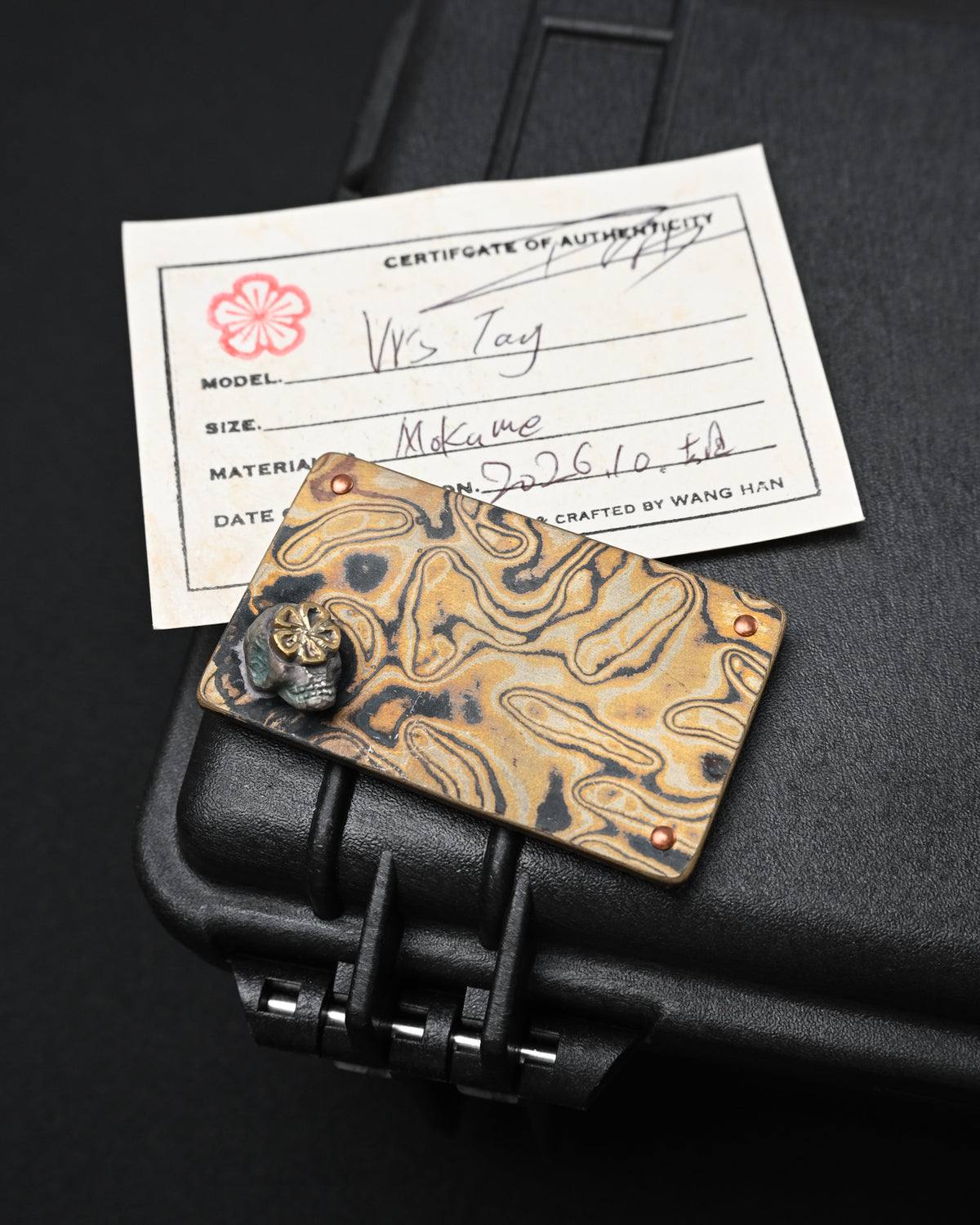 Wtopia handmade Mokume Gane EDC patch featuring a three-dimensional silver skull, bronze apricot blossom motif, three copper rivets and VELCRO hook backing
